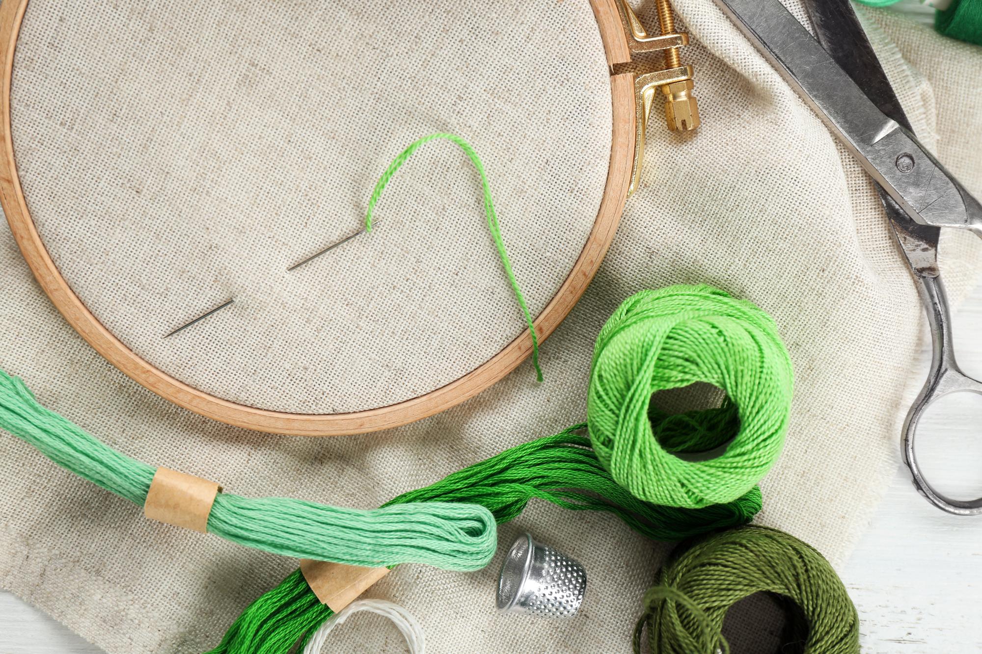 artist workspace with hoop and threads